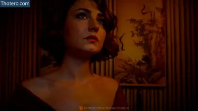 WhisperAudios ASMR - woman in a red dress looking away from the camera