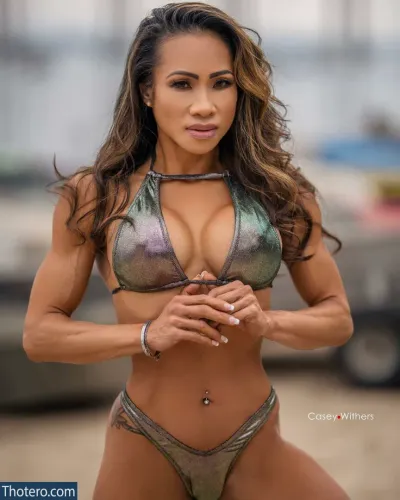 Wynne Melchor - a woman in a bikini posing for a picture in a parking lot