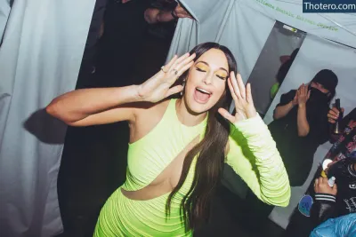 Kacey Musgraves - woman in a neon green dress making a funny face