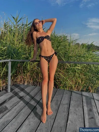libiazar - woman in a bikini posing on a wooden deck
