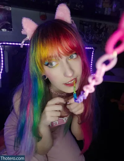 Xhajinx - girl with rainbow hair and cat ears blowing a chain