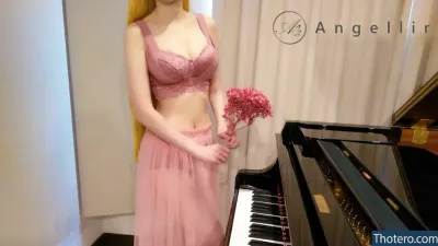 Pan Piano Payshare - there is a woman in a pink dress standing next to a piano