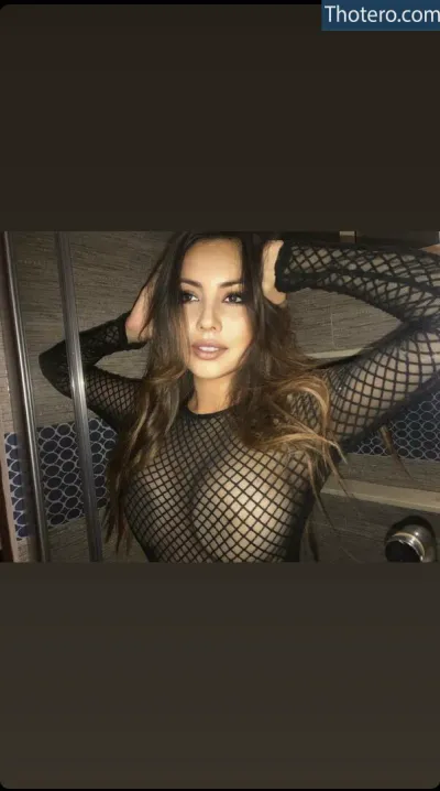 Jessvictoria - a close up of a woman in a fishnet top posing for a picture