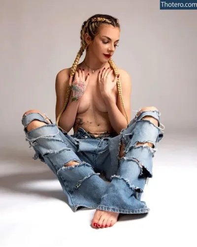 GothBaby_x - woman with braids sitting on the floor with her hands on her chest