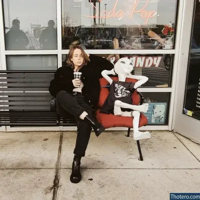 actuallyalisa - sitting on a chair with a cup of coffee in front of a store
