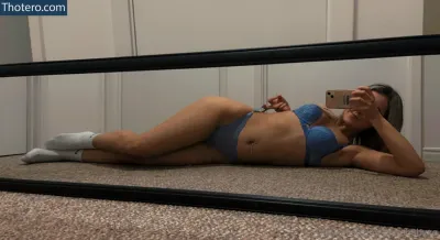 Hailey Jamieson - woman in a blue bikini laying on the floor taking a selfie