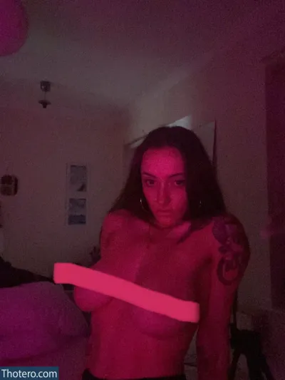 emilyautumn - woman holding a pink light in a dark room