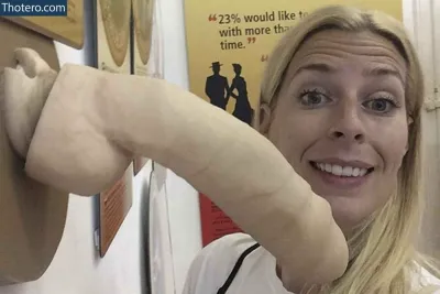 Sara Pascoe - woman holding a banana in front of a wall