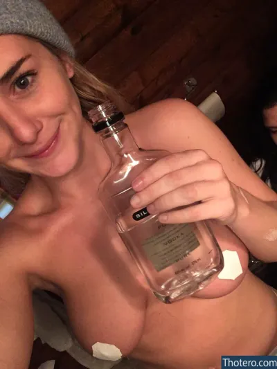 Addison Timlin - woman holding a bottle of alcohol in her hand