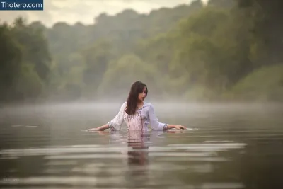 Diana Moon - woman in a white shirt is standing in the water