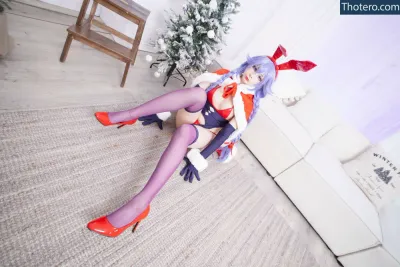 Akariia Cosplay - dressed in a sailor costume sitting on a couch