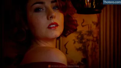 WhisperAudios ASMR - there is a woman with red hair and a red dress