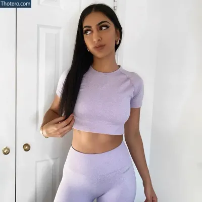 Reshxoxo - a woman in a purple top and leggings posing for a picture