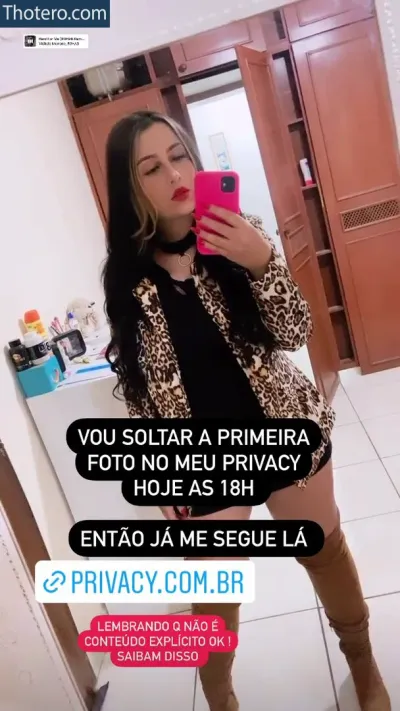 Camila Prado - a woman taking a selfie in a mirror with a phone