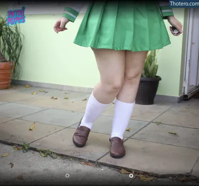Patripopes - there is a woman in a green skirt and white socks