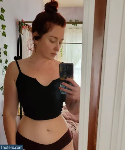gingerbwitched - woman in a black bra top taking a selfie in a mirror